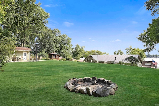 view of yard with a gazebo and a fire pit