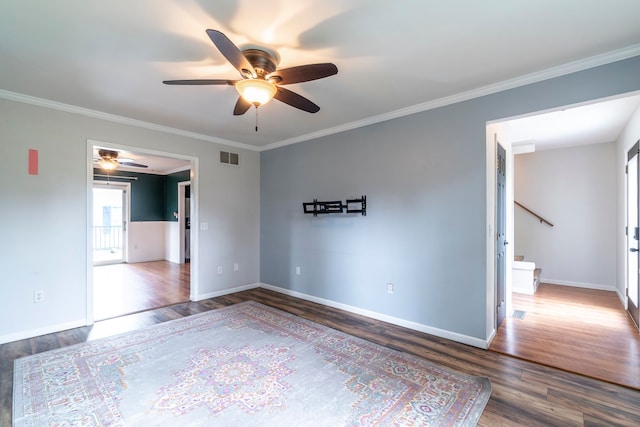 spare room with ceiling fan, hardwood / wood-style floors, and crown molding