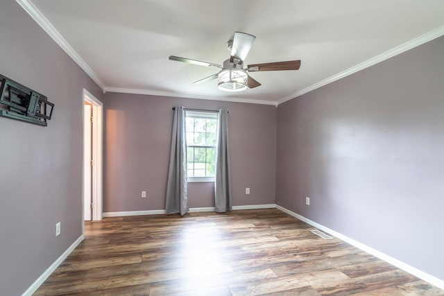 empty room featuring ornamental molding, ceiling fan, and hardwood / wood-style flooring