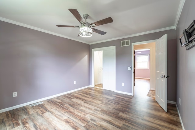 unfurnished bedroom with wood-type flooring, crown molding, and ceiling fan