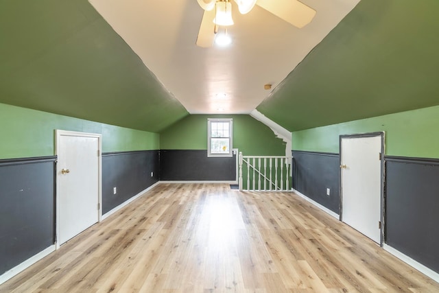 additional living space featuring light hardwood / wood-style flooring, lofted ceiling, and ceiling fan