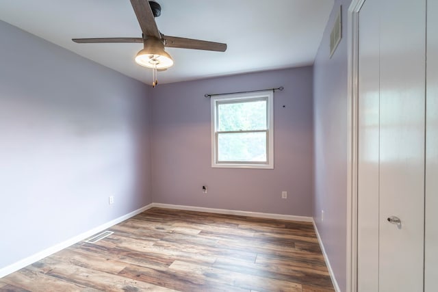 unfurnished room with ceiling fan and hardwood / wood-style flooring