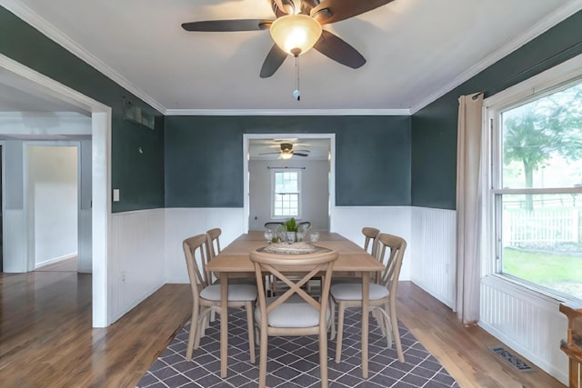 dining area featuring ornamental molding, hardwood / wood-style floors, and ceiling fan