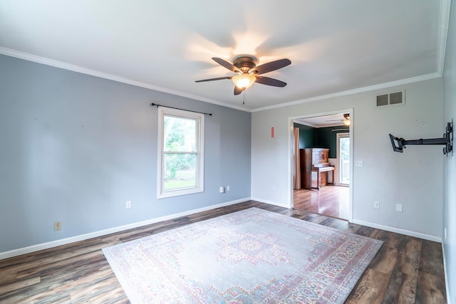 unfurnished room featuring crown molding, dark hardwood / wood-style floors, and ceiling fan