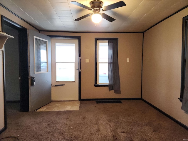 interior space featuring ceiling fan, light colored carpet, and plenty of natural light