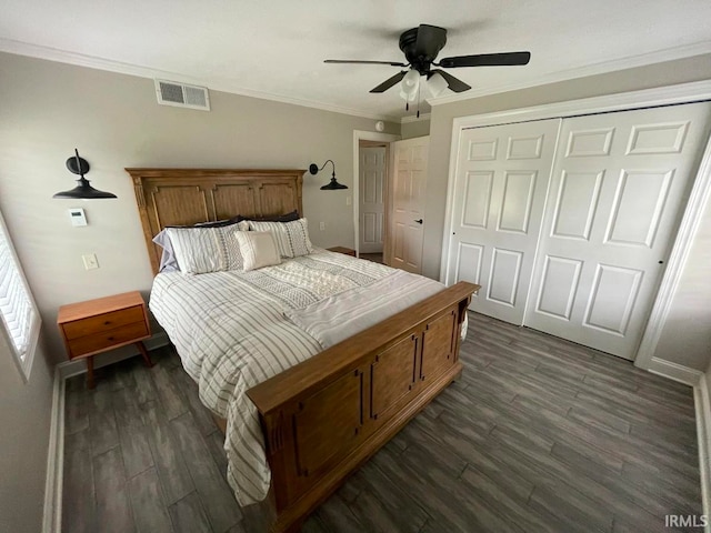 bedroom with ceiling fan, ornamental molding, a closet, and dark wood-type flooring