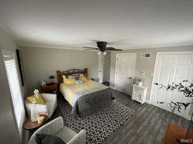 bedroom featuring ceiling fan, baseboards, ornamental molding, dark wood-type flooring, and visible vents