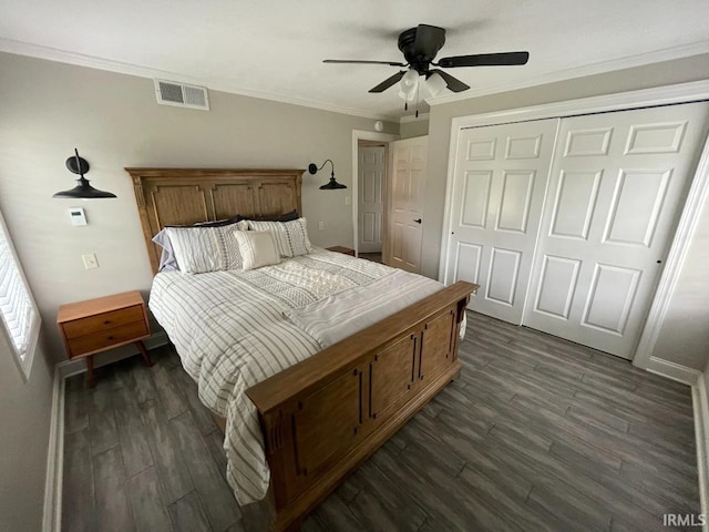 bedroom featuring visible vents, ornamental molding, a closet, dark wood-style flooring, and ceiling fan