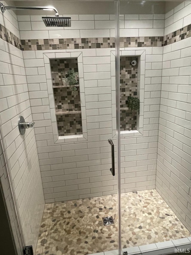 bathroom featuring a shower stall and visible vents