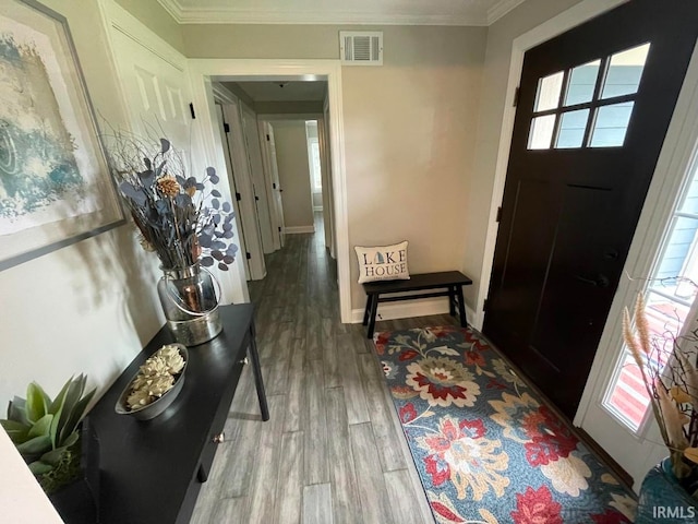 entryway featuring wood-type flooring and crown molding