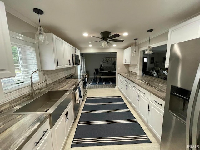 kitchen featuring stainless steel fridge, wood counters, and white cabinetry