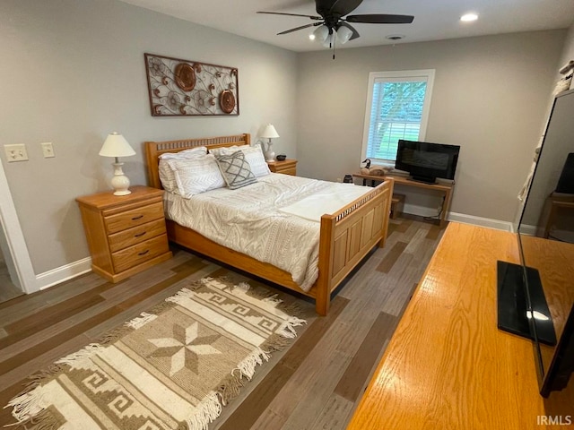 bedroom with ceiling fan and dark wood-type flooring