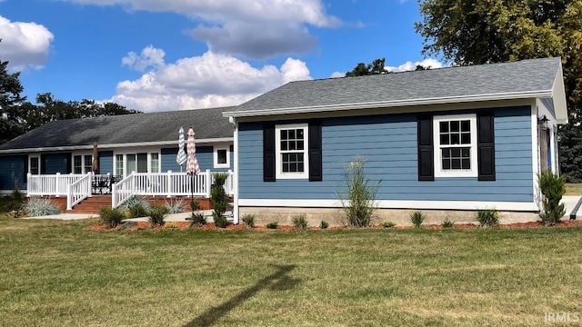 ranch-style home with a front lawn and a deck