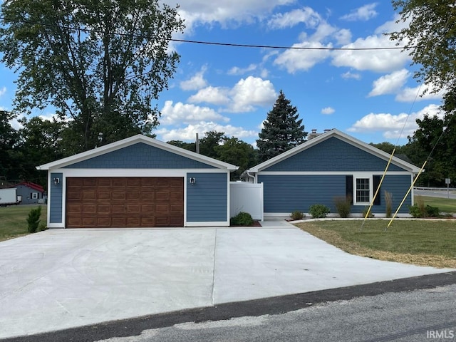single story home with fence, a front yard, and a garage