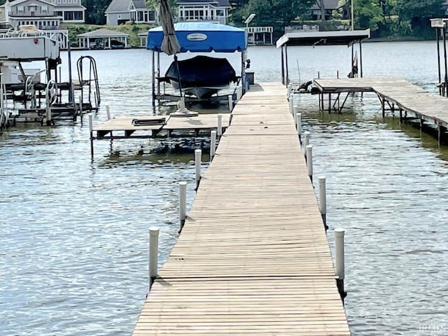 dock area featuring boat lift and a water view