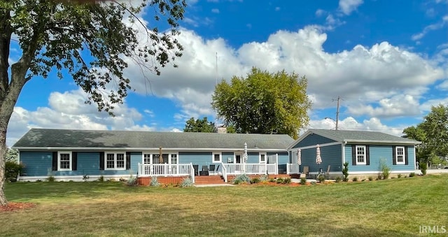 single story home with a wooden deck and a front yard