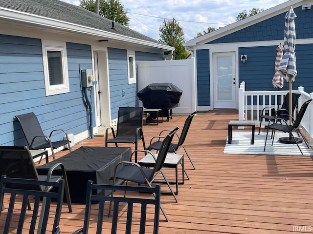 wooden terrace featuring a grill