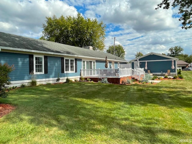 back of house featuring a yard and a deck