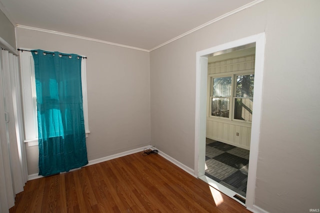 empty room featuring crown molding and hardwood / wood-style flooring