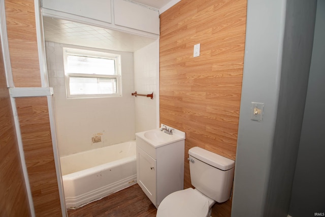 full bathroom with vanity, independent shower and bath, hardwood / wood-style floors, wooden walls, and toilet