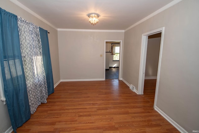 hall with hardwood / wood-style flooring and crown molding