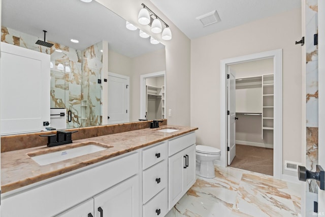 bathroom featuring vanity, toilet, and an enclosed shower