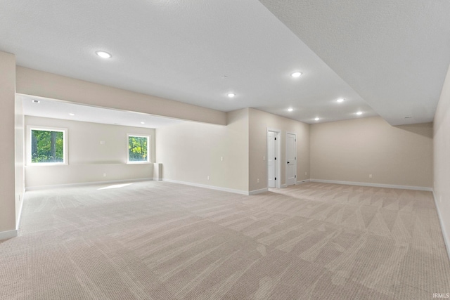 basement featuring light carpet