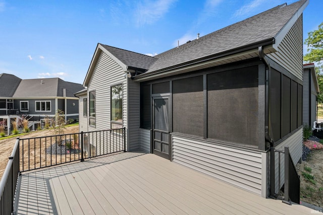 wooden deck featuring a sunroom