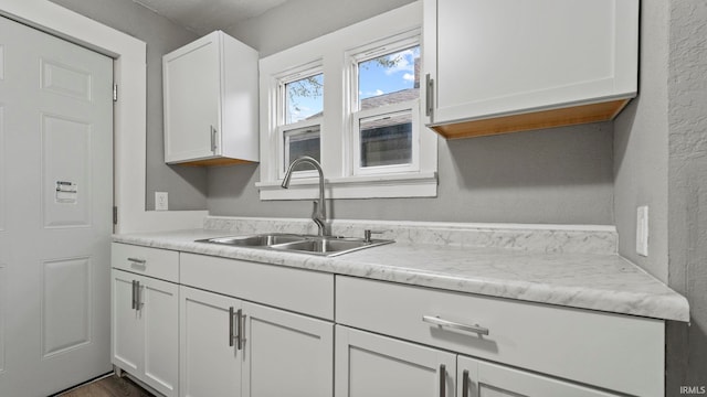 kitchen featuring sink and white cabinetry