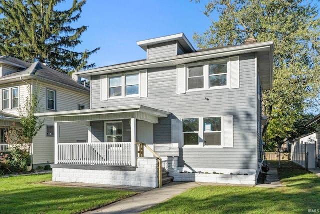 view of front facade with a front lawn and a porch