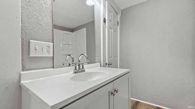 bathroom featuring vanity and hardwood / wood-style floors