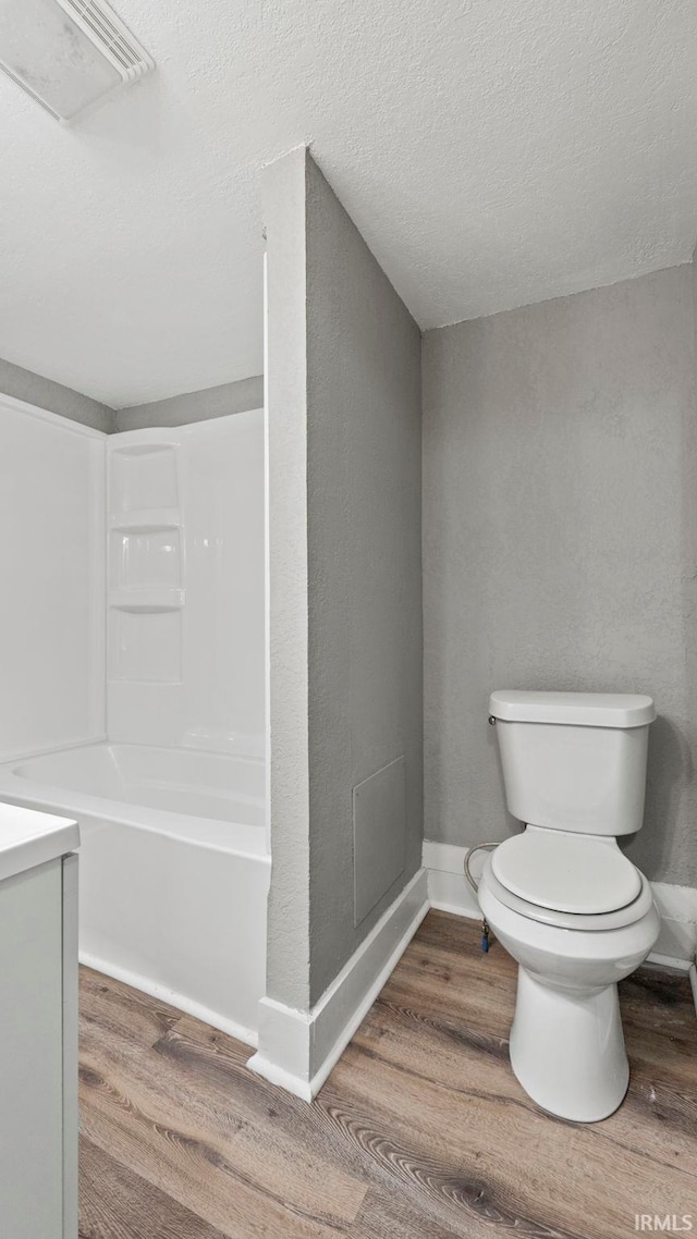 full bathroom with vanity, toilet, and hardwood / wood-style floors