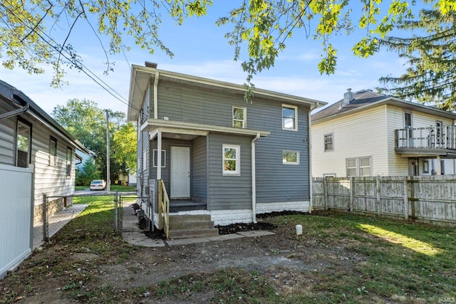 rear view of property featuring a balcony