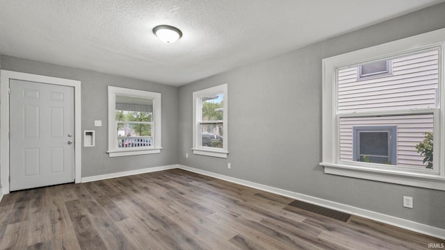 entrance foyer featuring a textured ceiling and hardwood / wood-style flooring