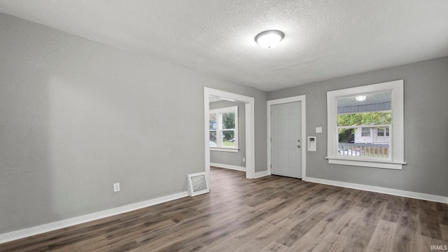 entryway with a textured ceiling and hardwood / wood-style floors