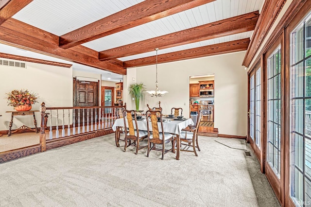 dining area featuring beamed ceiling, light carpet, french doors, and a chandelier