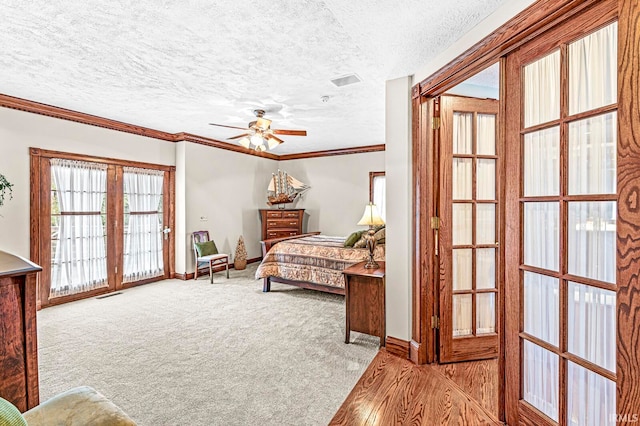 bedroom with french doors, ceiling fan, a textured ceiling, and access to outside