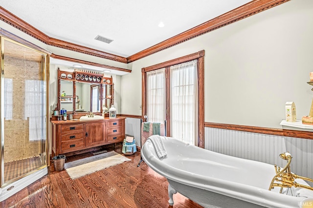 bathroom with vanity, a textured ceiling, wood-type flooring, separate shower and tub, and ornamental molding