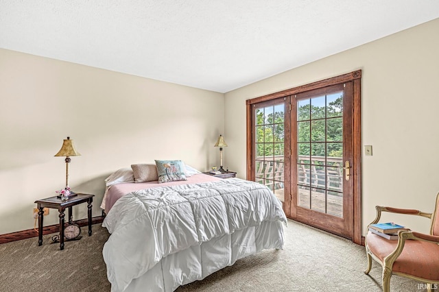 carpeted bedroom with access to outside and a textured ceiling