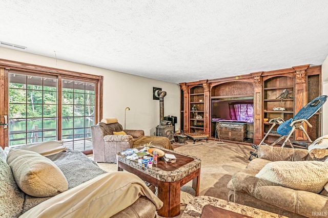 carpeted living room featuring a textured ceiling and a wood stove