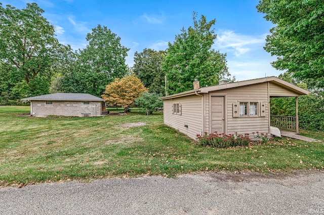 view of side of property with a lawn