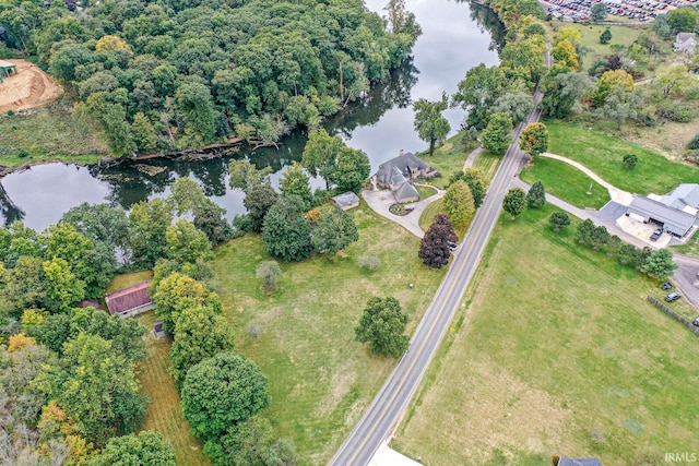 birds eye view of property with a water view