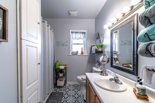 bathroom featuring tile patterned flooring, vanity, and toilet