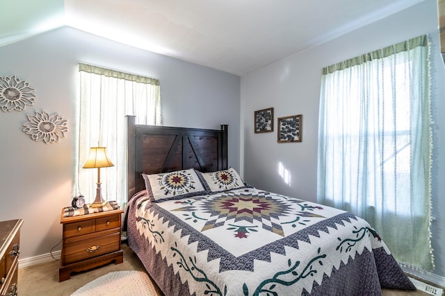 bedroom with lofted ceiling and carpet flooring