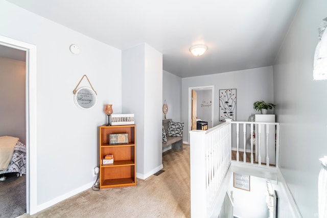 hallway with light colored carpet