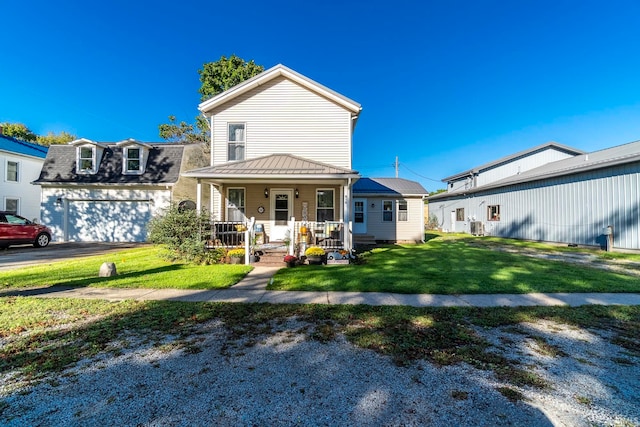 view of front of property with a garage, a front lawn, and covered porch