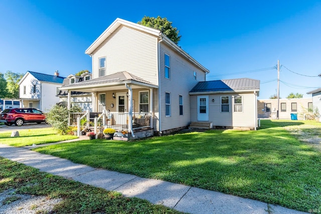 view of front of property featuring a front lawn and covered porch