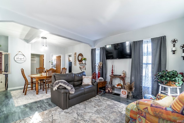 living room with a notable chandelier, dark hardwood / wood-style flooring, beamed ceiling, and plenty of natural light