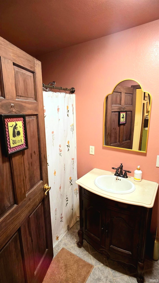 bathroom with walk in shower and vanity