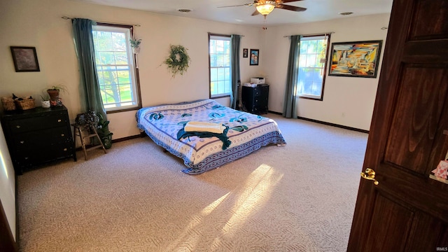 bedroom with ceiling fan and light colored carpet